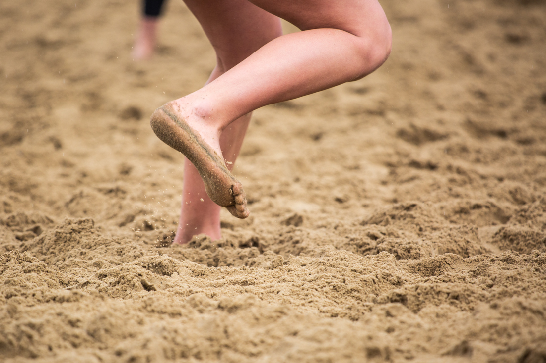 Beach volleyball players kick up sand with their feet. Oregon Ducks beach volleyball takes on the Portland Pilots at Amazon Park in Eugene, Ore. on April 6, 2019. (Sarah Northrop/Emerald)