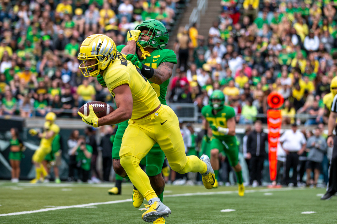 Oregon Ducks cornerback Thomas Graham Jr. (4) grabs another player's helmet as he runs away with the ball. Oregon Ducks football&#160;&#160;plays in the Spring game at Autzen Stadium in Eugene, Ore. on April 20, 2019. (Maddie Knight/Emerald)