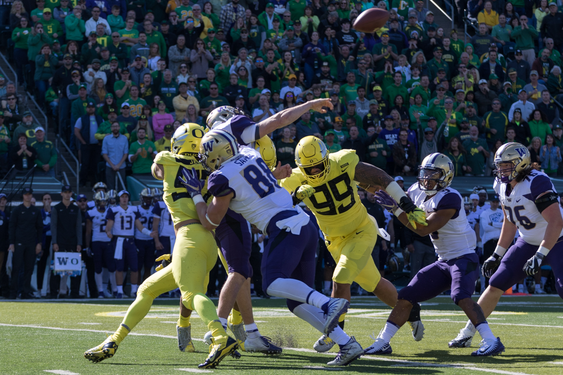 Huskies quarterback Jake Browning (3) gets the throw off despite heavy defensive pressure. Oregon Ducks Football takes on University of Washington at Autzen Stadium on Oct. 13, 2018. (Ben Green/Emerald)