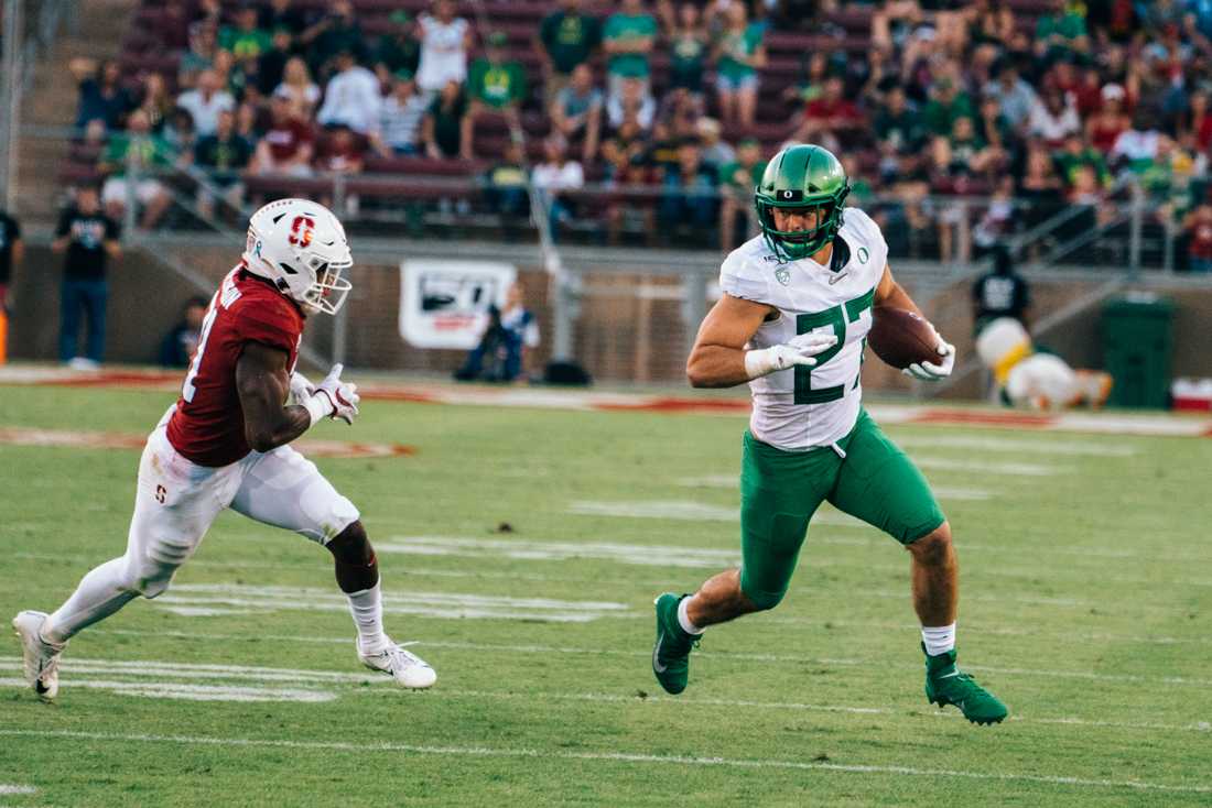 <p>Ducks tight end Jacob Breeland (27) sprints past a defender for the first down. Oregon Ducks football takes on the Stanford Cardinal at Stanford Stadium in Stanford, Calif. on Sept. 21, 2019. (Connor Cox/Emerald)</p>