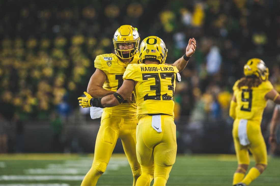 Ducks quarterback Justin Herbert (10) celebrates with running back Cyrus Habibi-Likio (33) after a successful drive. Oregon Ducks Football takes on the Colorado Buffaloes at Autzen Stadium in Eugene, Ore. on Oct. 11, 2019. (DL Young/Emerald)