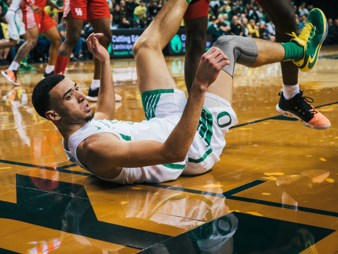 Ducks guard Chris Duarte (5) hits the ground after a collision. Oregon Ducks men&#8217;s basketball takes on University of Houston at Matthew Knight Arena in Eugene, Ore. on Nov. 22, 2019. (Connor Cox/Emerald)