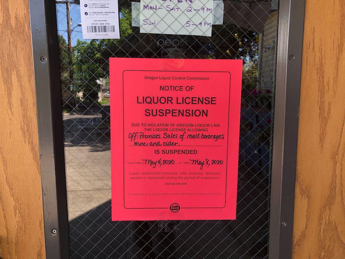 The notice posted outside Cottage Market on Hilyard on May 4. The store's liquor license was suspended for four days for a 2019 sale to a minor. (Michael Tobin/Emerald)