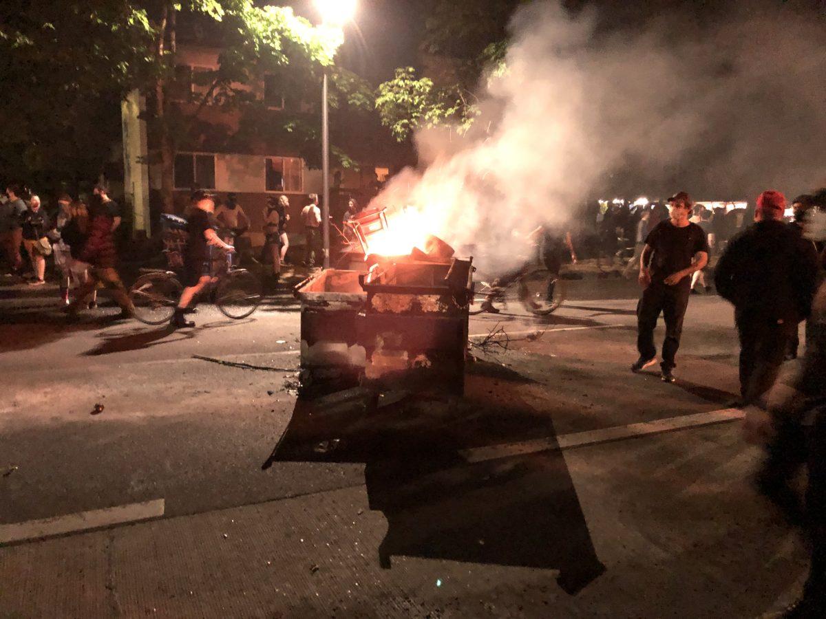 A burning dumpster on West 7th Avenue. (Michael Tobin/Emerald)