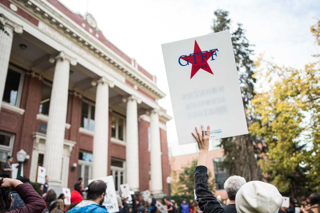 <p>Rachel Hampton, VP of operations at GTFF, uses a sign as her voice. Following the vote to authorize a strike, the Graduate Teaching Fellows Federation holds a rally to demand a fair contract at Johnson Hall on Oct. 18, 2019. (Marissa Willke/Emerald)</p>