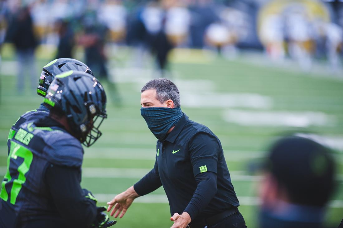 Head Coach Mario Cristobal high fives player during the warmups. Oregon Ducks football takes on the UCLA Bruins at Autzen Stadium in Eugene, Ore., on Nov. 21, 2020. (DL Young/Emerald)