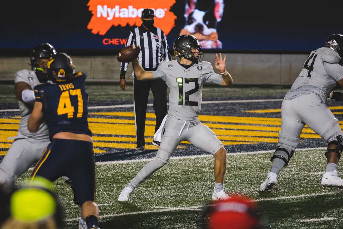 Ducks quarterback Tyler Shough (12) throws from the pocket. Oregon Ducks football takes on the California Golden Bears at California Memorial Stadium in Berkeley, Calif., on Dec. 5, 2020. (DL Young/Emerald)