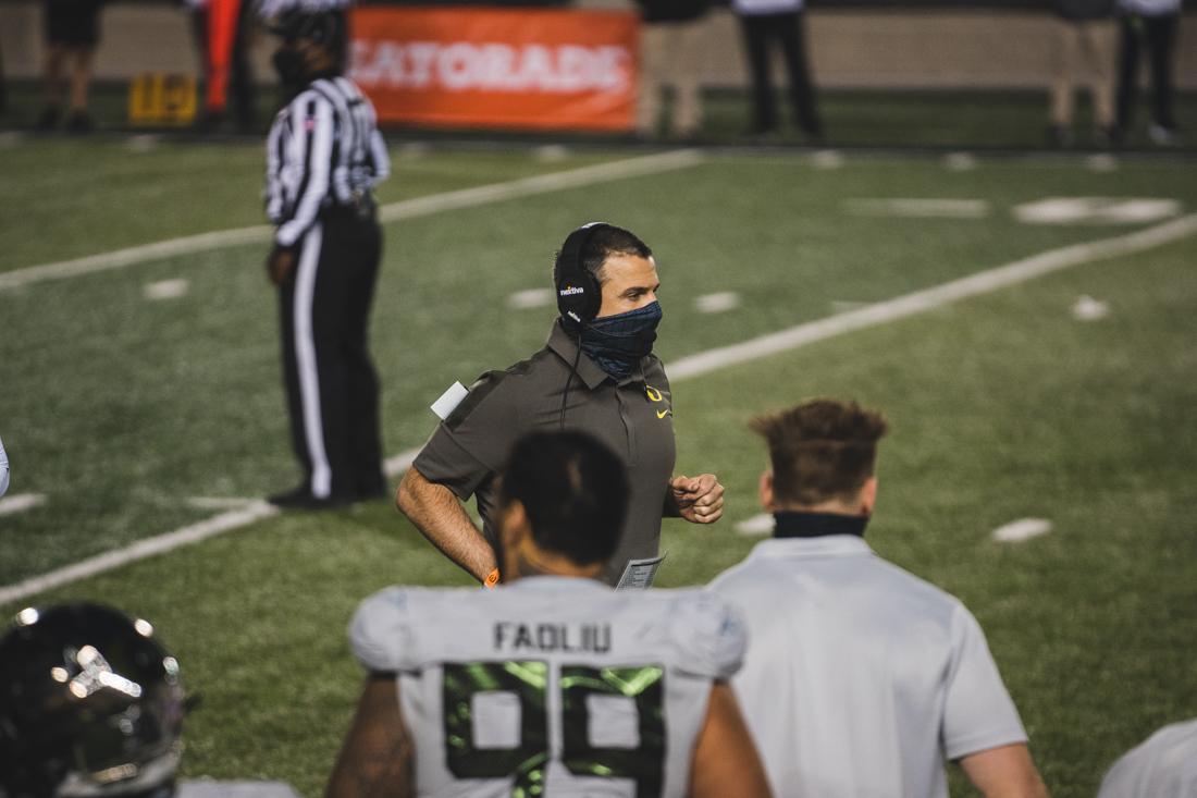 Ducks Head Coach Mario Cristobal runs back to the sideline. Oregon Ducks football takes on the California Golden Bears at California Memorial Stadium in Berkeley, Calif., on Dec. 5, 2020. (DL Young/Emerald)