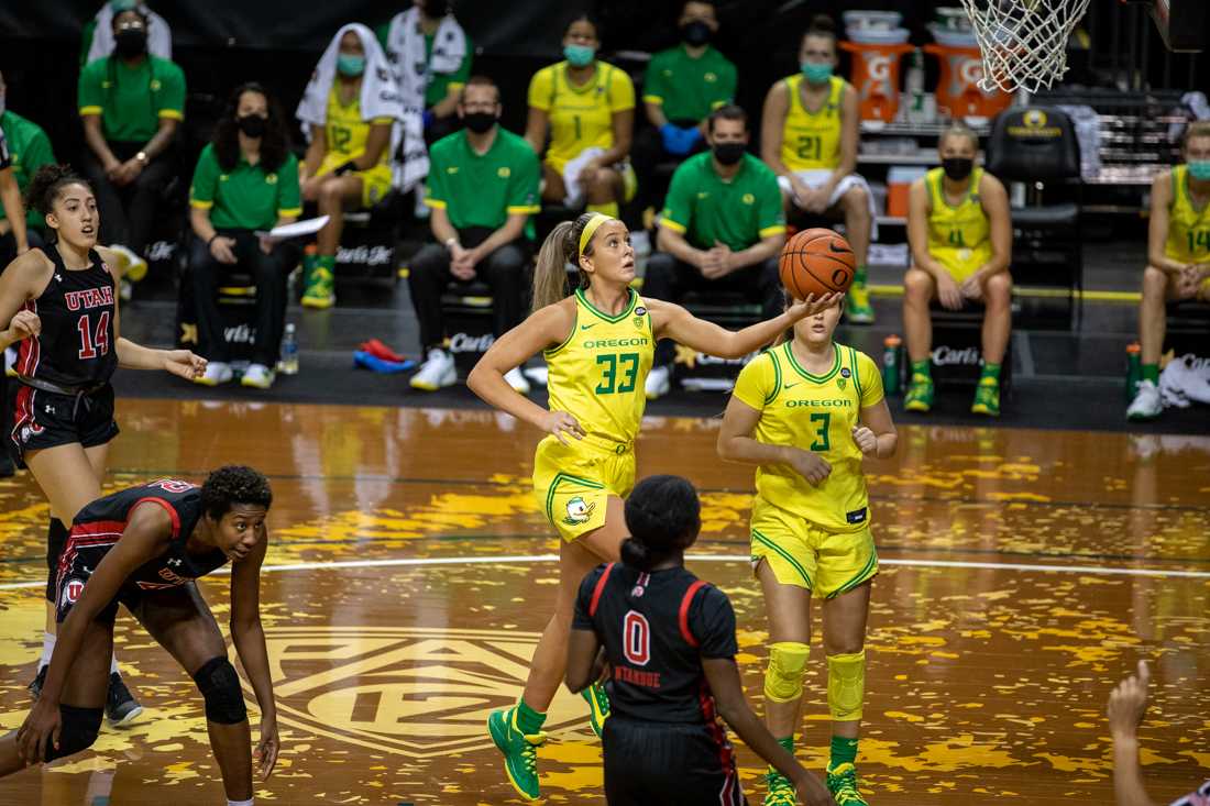 Ducks guard Sydney Parrish (33) lifts the ball towards the net. Oregon Ducks women&#8217;s basketball takes on the Utah Utes at Matthew Knight Arena in Eugene, Ore., on Dec. 6, 2020. (Maddie Knight/Emerald)