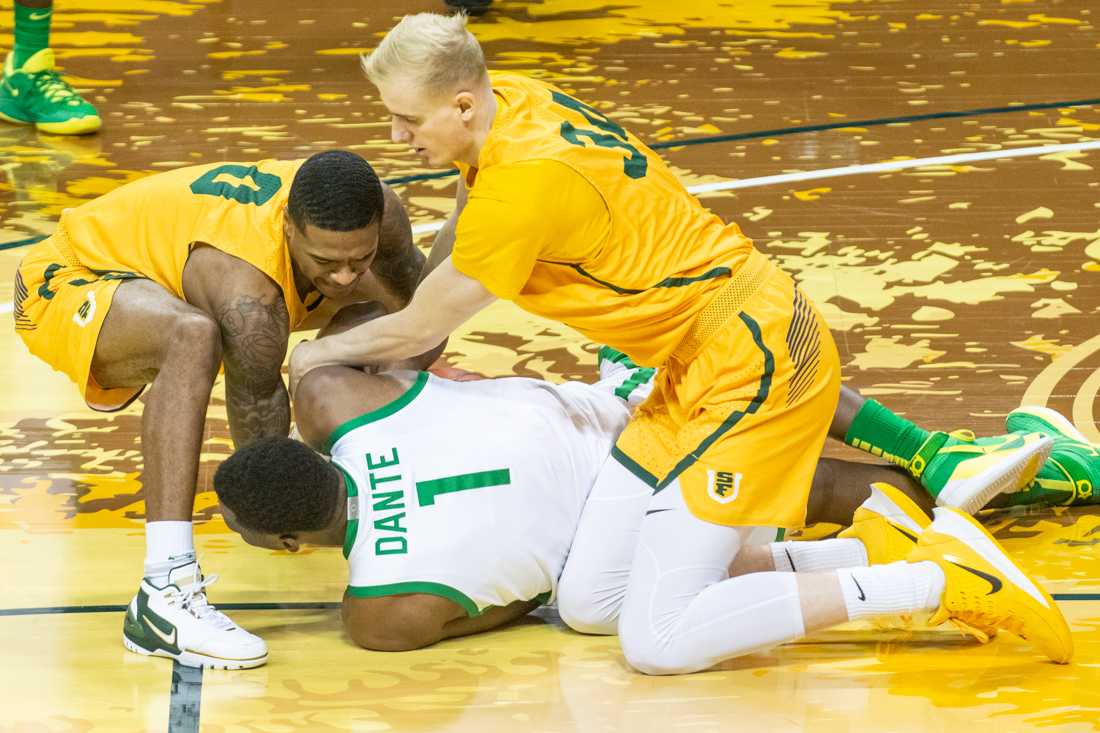 Dons get a foul attempting to grab the ball away from Ducks center N&#8217;faly Dante (1). Oregon Ducks take on San Francisco Dons at Matthew Knight Arena in Eugene, Ore., on Dec. 17, 2020. (Kimberly Harris/Emerald)