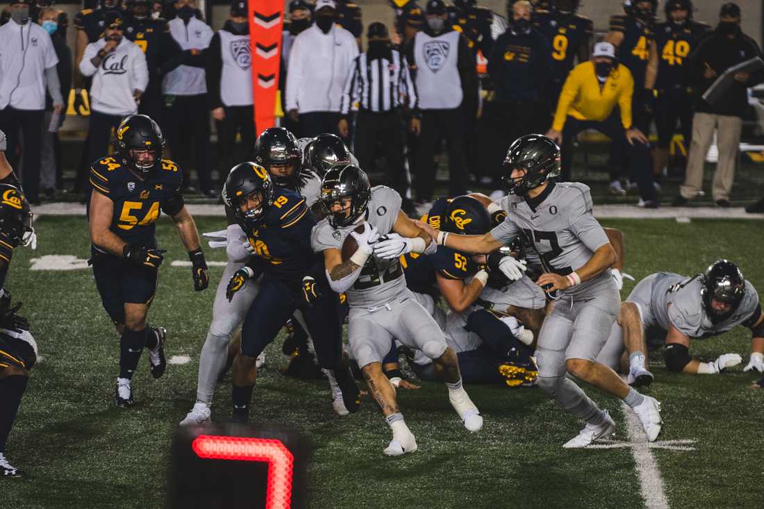 Ducks running back Cyrus Habibi-Likio (33) runs for a short gain. Oregon Ducks football takes on the California Golden Bears at California Memorial Stadium in Berkeley, Calif., on Dec. 5, 2020. (DL Young/Emerald)