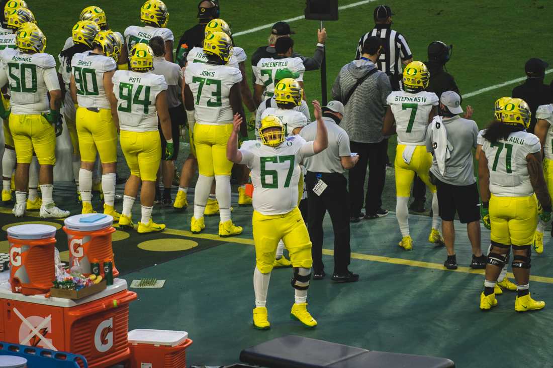 Ducks offensive lineman Cole Young (67) tries to get teh crowd pumped. Oregon Ducks football takes on Iowa State for the Fiesta Bowl at State Farm Stadium in Glendale, Ariz., on Jan. 2, 2021. (DL Young/Emerald)