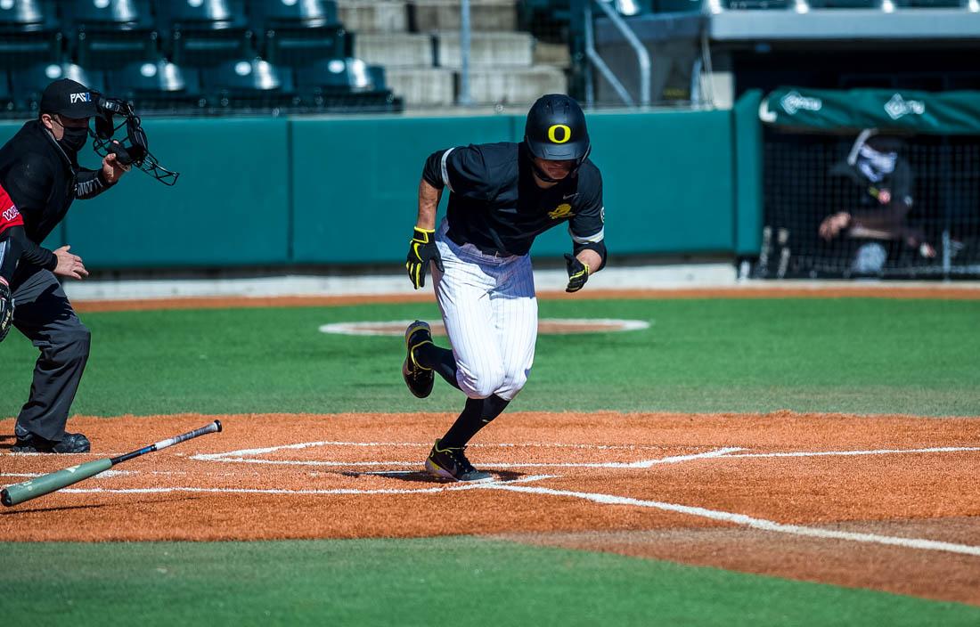 <p>Ducks infielder Josh Kasevich (4) runs to first base. Oregon Ducks baseball takes on the Seattle University RedHawks at PK Park in Eugene, Ore., on Feb. 28, 2021. (Ian Enger/Emerald)</p>