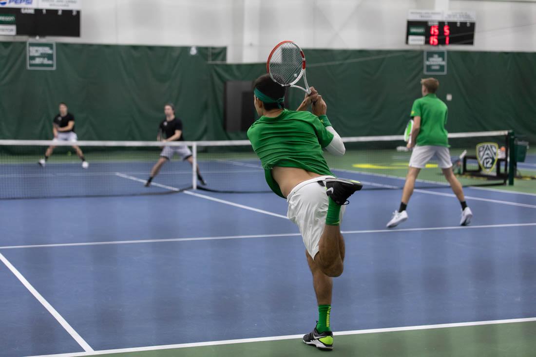 Ducks senior Brandon Lam finishes hitting the ball. Oregon Ducks men's tennis take on Portland State Vikings at the Student Tennis Center on Feb. 06, 2021. (Maddie Stellingwerf/Emerald)