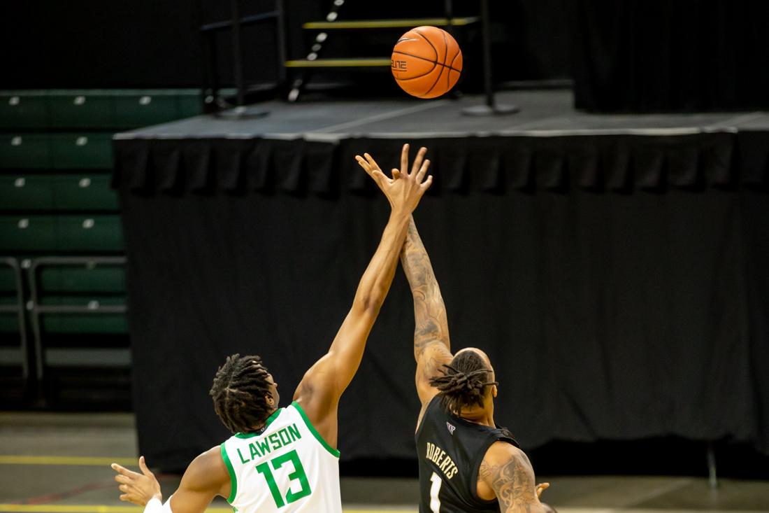 Washington Huskies win over the ball at tip off. Oregon Ducks take on the Washington Huskies at the Matthew Knight Arena in Eugene, Ore., on Feb. 6, 2021. (Maddie Knight/Emerald)