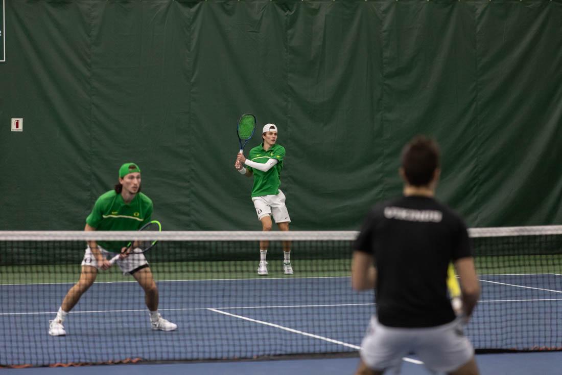 Ducks duo's Luke Vandecasteele and Quinn Vandecasteele hit the ball back against the Vikings. Oregon Ducks men's tennis take on Portland State Vikings at the Student Tennis Center on Feb. 06, 2021. (Maddie Stellingwerf/Emerald)