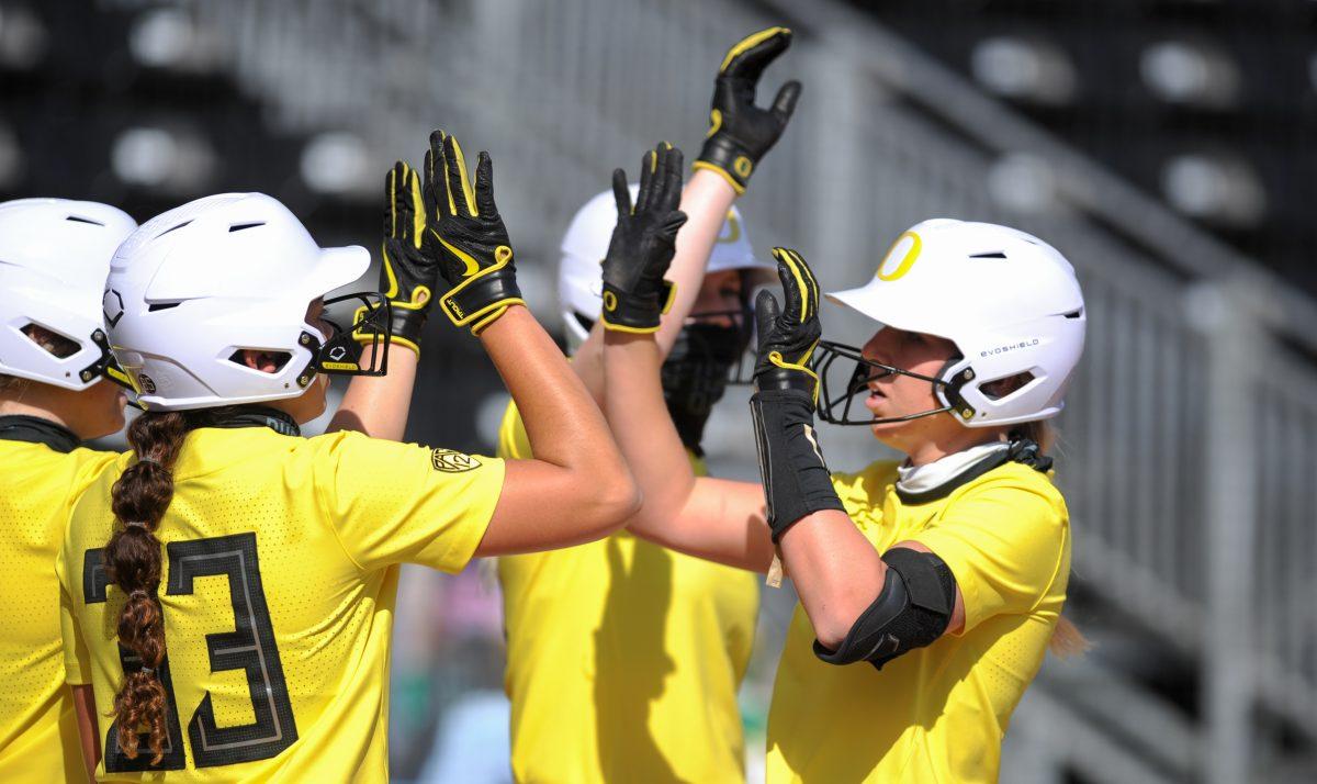 Ducks catcher Terra McGowan (11) high-fives her teammates after a home-run. Oregon Softball takes on Sacramento State at Jane Sanders Stadium in Eugene, Ore., on March 13, 2021. (Summer Surgent-Gough/Emerald)