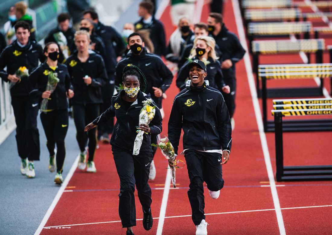 University of Oregon seniors take a lap around the track after receiving their end of college career awards. The University of Oregon hosts the Oregon Twilight for track and field at Hayward Field in Eugene, Ore., May 5th, 2021. (Ian Enger/Emerald)