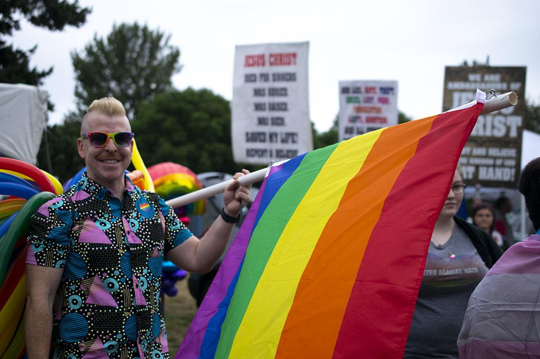 The festival continues while a counter-protest stands on the side.&#160;Eugene Springfield Pride in the Park takes place at Alton Baker Park on Aug. 10, 2019. (Kimberly Harris/Emerald)