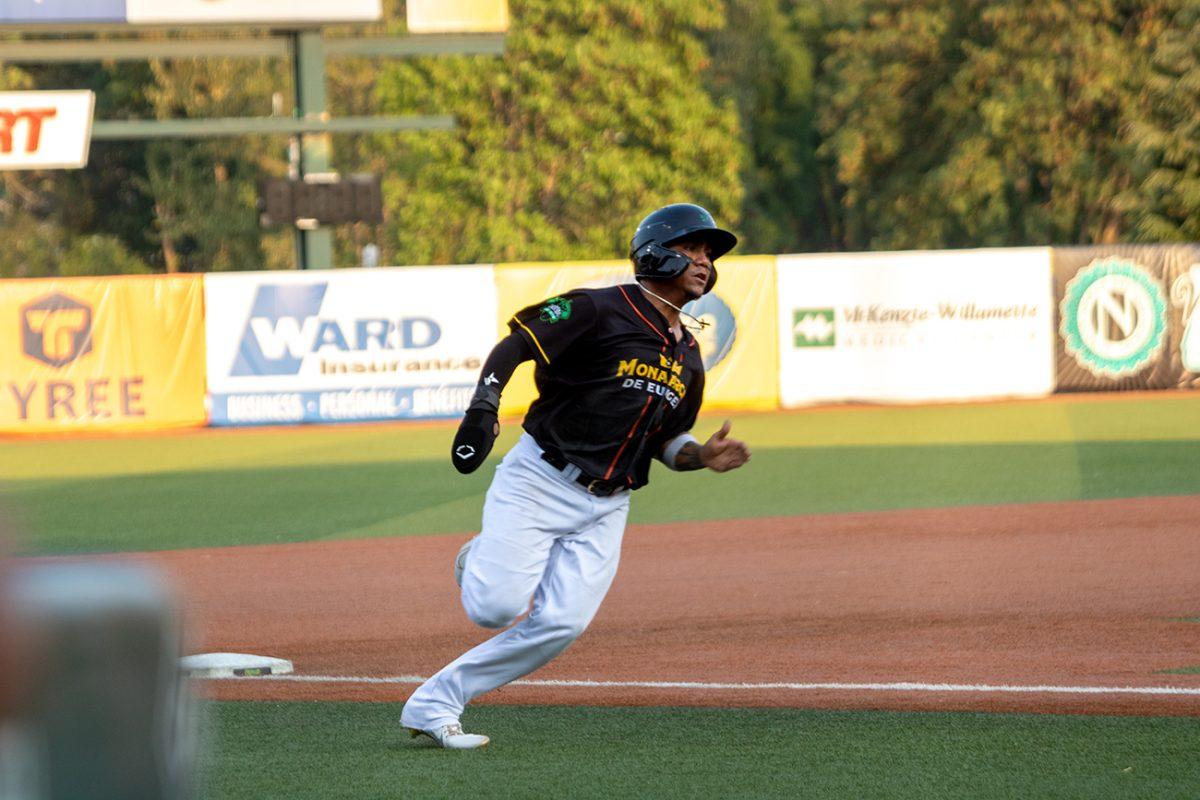 <p>Ismael Munguia (38) rounds third base to score a run. The Eugene Emeralds, who played under their alternate name Monarcas de Eugene, defeated the Tri-City Dust Devils 11-4 on Tuesday, August 3, at PK Park in Eugene, Oregon. (Will Geschke/Emerald)</p>