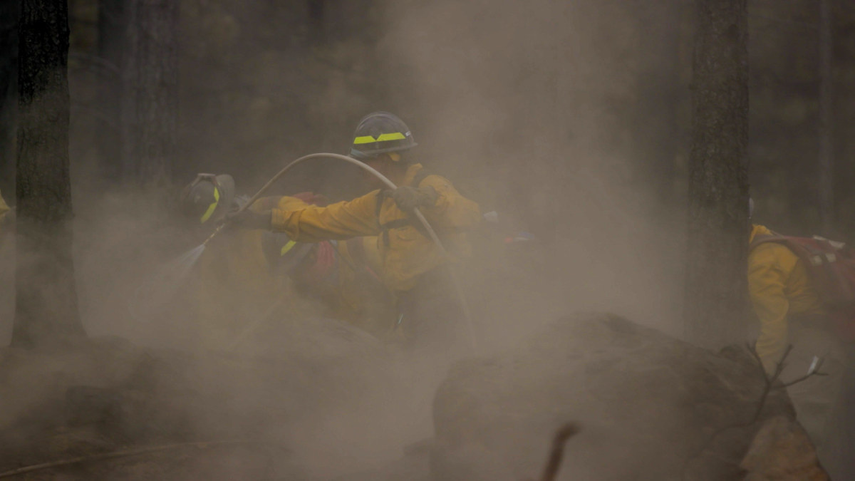 A crew of firefighters &#8220;mops up,&#8221; or makes sure the contained fire is safe and reduces residual smoke, at the site of the Bootleg Fire on July 26. (Marcus Ren/Daily Emerald)