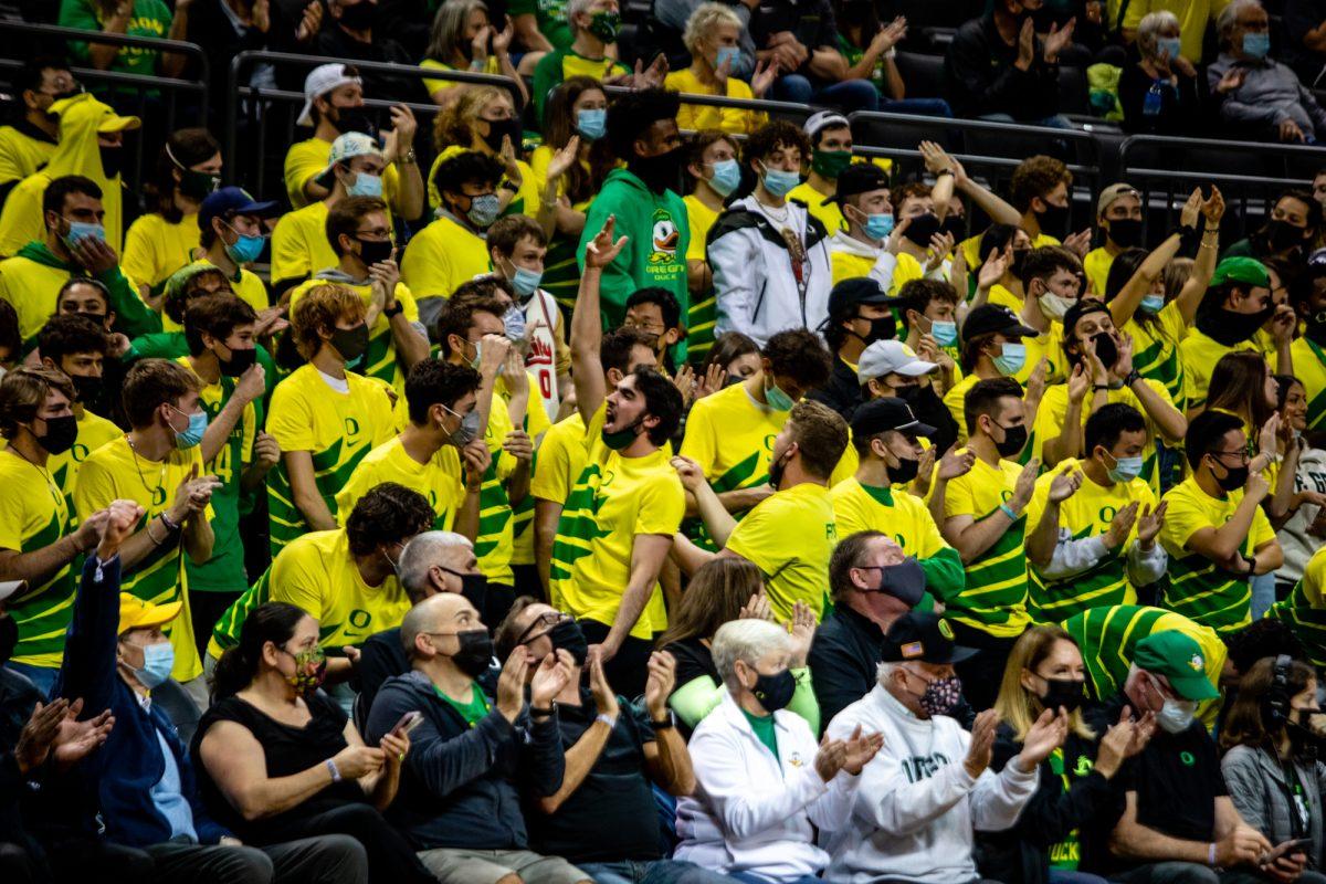 Oregon Ducks fans in the student section celebrate a three pointer. The Oregon Ducks defeated the Southern Methodist University Mustangs 86-63 at Matthew Knight Arena on November 12, 2021. (Will Geschke/Emerald)