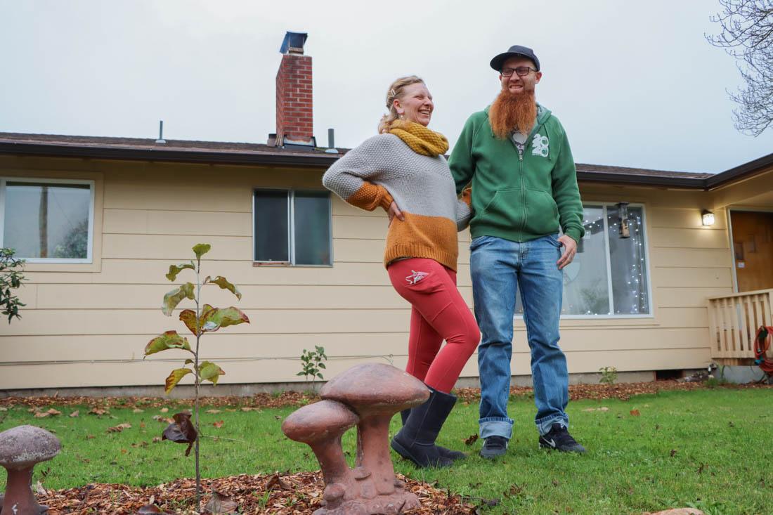 Matt Holsonvack and Rachel Grudzien stand together in their front yard of their quaint Eugene home. The Oregon couple shares their passion and knowledge of mushroom foraging and handling in the PNW. (Mary Grosswendt/Emerald)