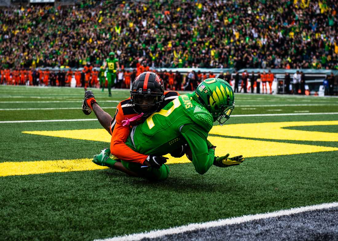 Ducks wide receiver Devon Williams (2) is tackled into the endzone by Beavers defensive back Rejzohn Wright (1) after hauling in a 50-yard touchdown. The University of Oregon Ducks hosted and defeated the Oregon State Beavers 38-29, claiming the Pac-12 North champions title. (Emerald/ Ian Enger)