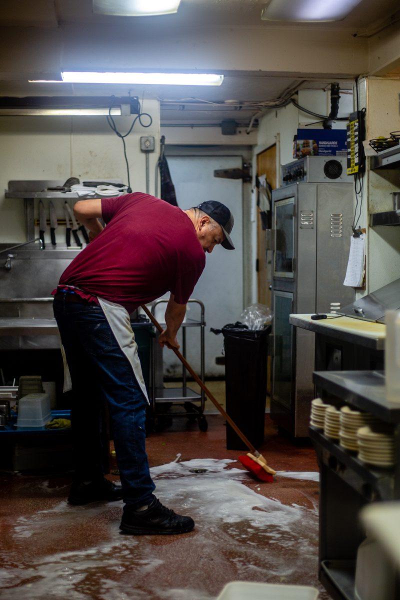 Javier Carrillo cleans the floors of the kitchen shortly after the Glenwood closes for the day. Carrillo has been working at the Glenwood for 26 years, along with his brother, Jorge. The Glenwood Resturaunt, a staple in the Eugene community for 38 years, is being sold to a developer to construct apartment buildings on the property. (Will Geschke/Emerald)