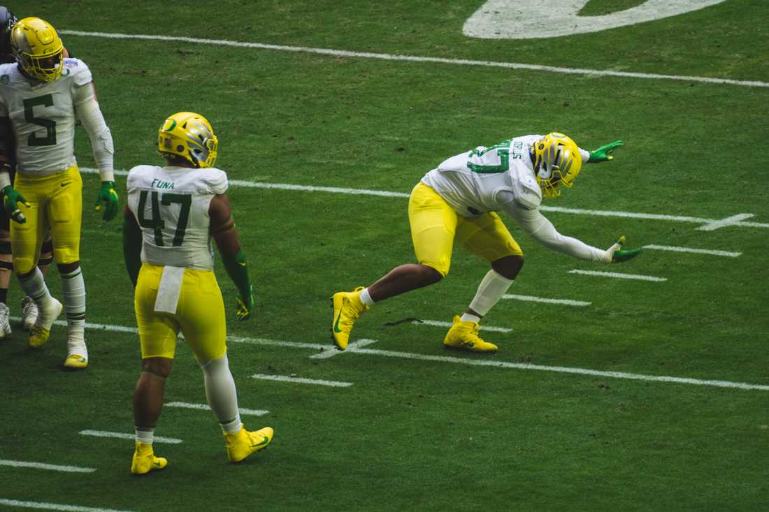 Ducks defensive tackle Brandon Dorlus (97) celebrates a defensive stop. Oregon Ducks football takes on Iowa State for the Fiesta Bowl at State Farm Stadium in Glendale, Ariz., on Jan. 2, 2021. (DL Young/Emerald)