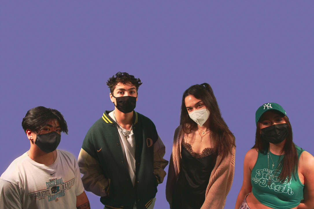 (From left to right): Tevon Phomphakdy, Gabe Lopez, Sydney Chen, and Kennedy Hjelte pose for a group photo in front of a green backdrop in the studio. (Sammie Claire // The Daily Emerald)