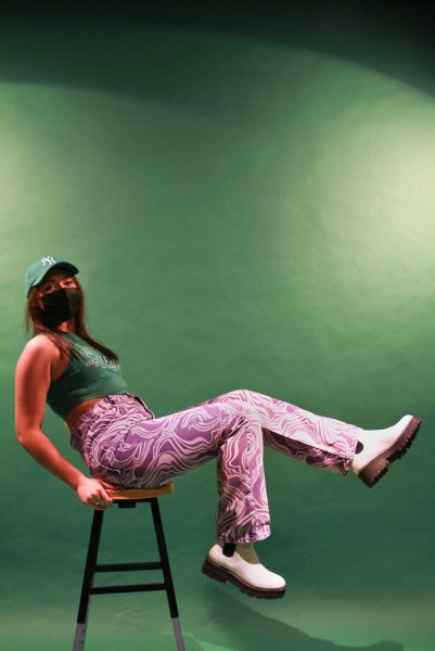 Kennedy Hjelte's purple pants are her favorite pants. She got them from Zara and loves the crazy colorful vibe. She says they really fit her personal style. Her green shirt is from Shein. (Sammie Claire // The Daily Emerald)