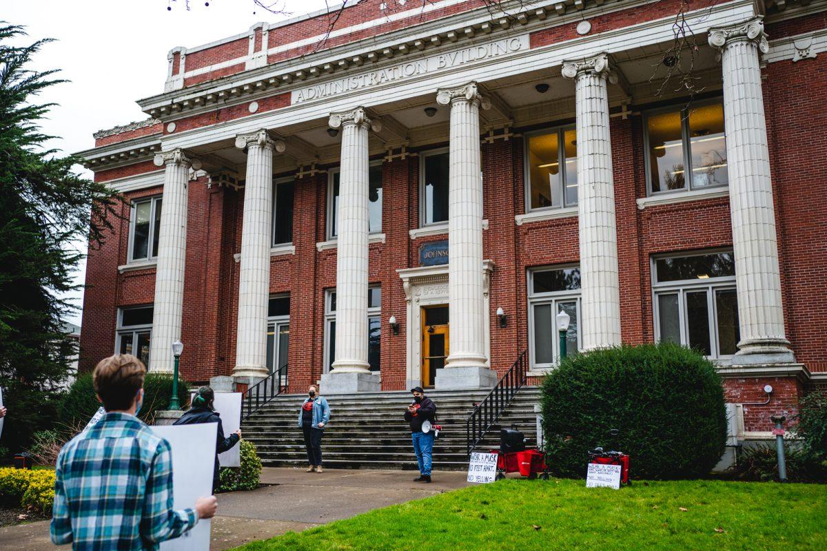 Members of the GTFF make speeches in front of Johnson Hall on the University of Oregon campus. Graduate teachers, students, and community members gathered outside Johnson Hall on Tuesday, Jan. 18th to protest unsafe learning and working conditions following the increase of COVID-19 cases on the University of Oregon campus. (Will Geschke/Emerald)