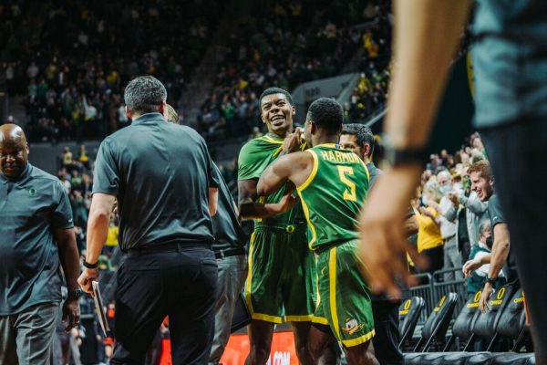 De'Vion Harmon (5, right) lifts up Eric Williams Jr (left) after Williams sank a shot from half court to end the first half. The Oregon Ducks Men’s Basketball team faces the Oregon State Beavers, on January 29th, 2022, at Matthew Knight Arena. (Serei Hendrie/Emerald)