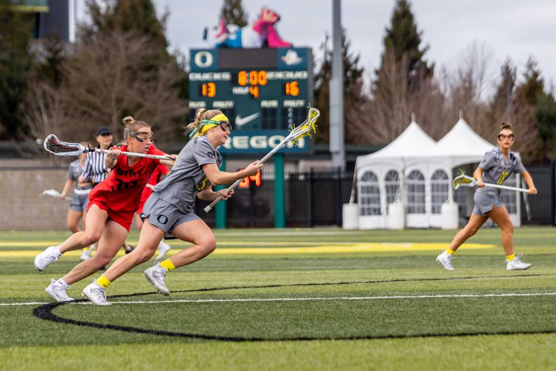 Morgan McCarthy (05) beats her defender and drives to the goal. The Oregon Ducks Women&#8217;s Lacrosse team takes on the SDSU Aztecs, on February 27th, 2022. (Molly McPherson/Emerald)