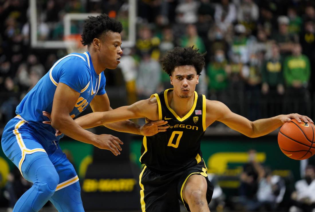 Ducks guard Will Richardson (0) drives around a defender. The Oregon Ducks get the win over UCLA at Matthew Knight Arena in Eugene, Ore. on Feb. 24, 2022. (Jackson Knox/Emerald)