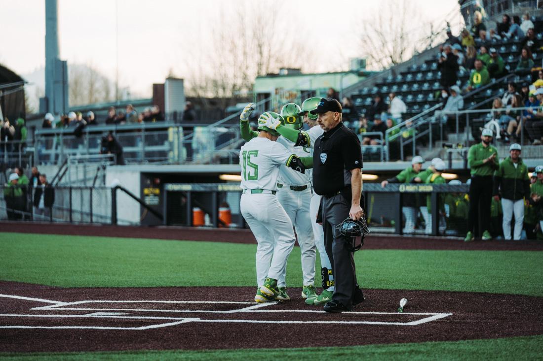 Drew Cowley clebrates with teamates after hitting a home run and sending another runner in. The Oregon Ducks Baseball team faces Saint Johns, in their home opener on February 25th, 2022, at PK Park in Eugene, Ore. (Serei Hendrie/Emerald)