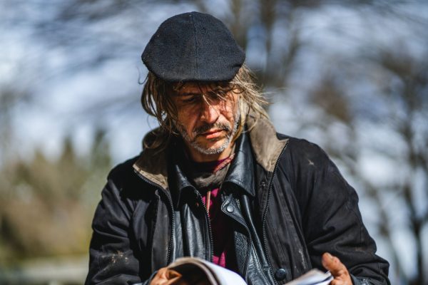 Charles Petty II looks through his notebook, filled with his art and poetry. Washington Jefferson Park, which has served as a sanctioned campsite for unhoused people for a year, will be closed by the city soon. (Will Geschke/Emerald)