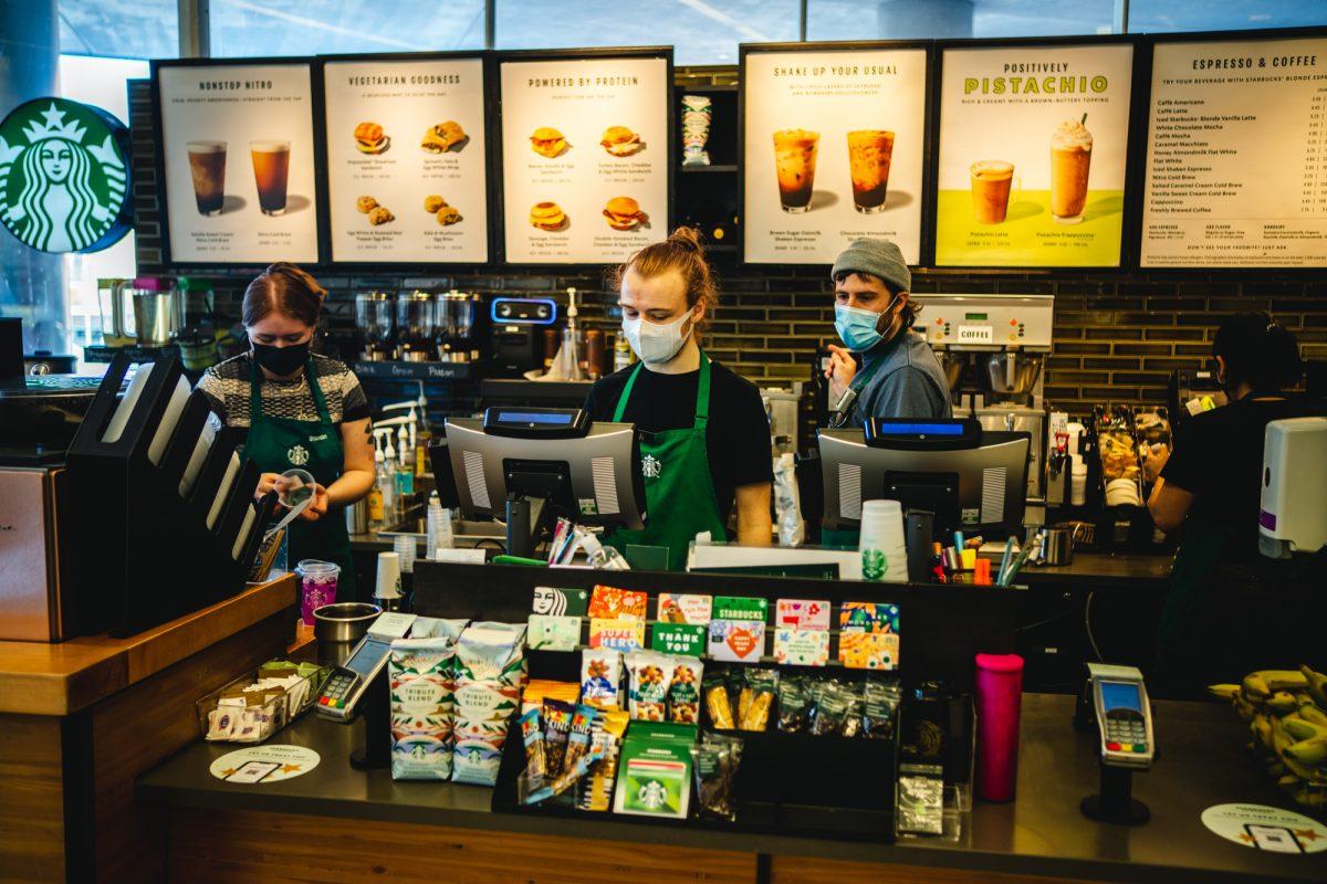 Starbucks employees fullfil the constant stream of orders during the day. The Starbucks in the ERB Memorial Union on campus is working towards unionizing their workforce. (Will Geschke/Emerald)