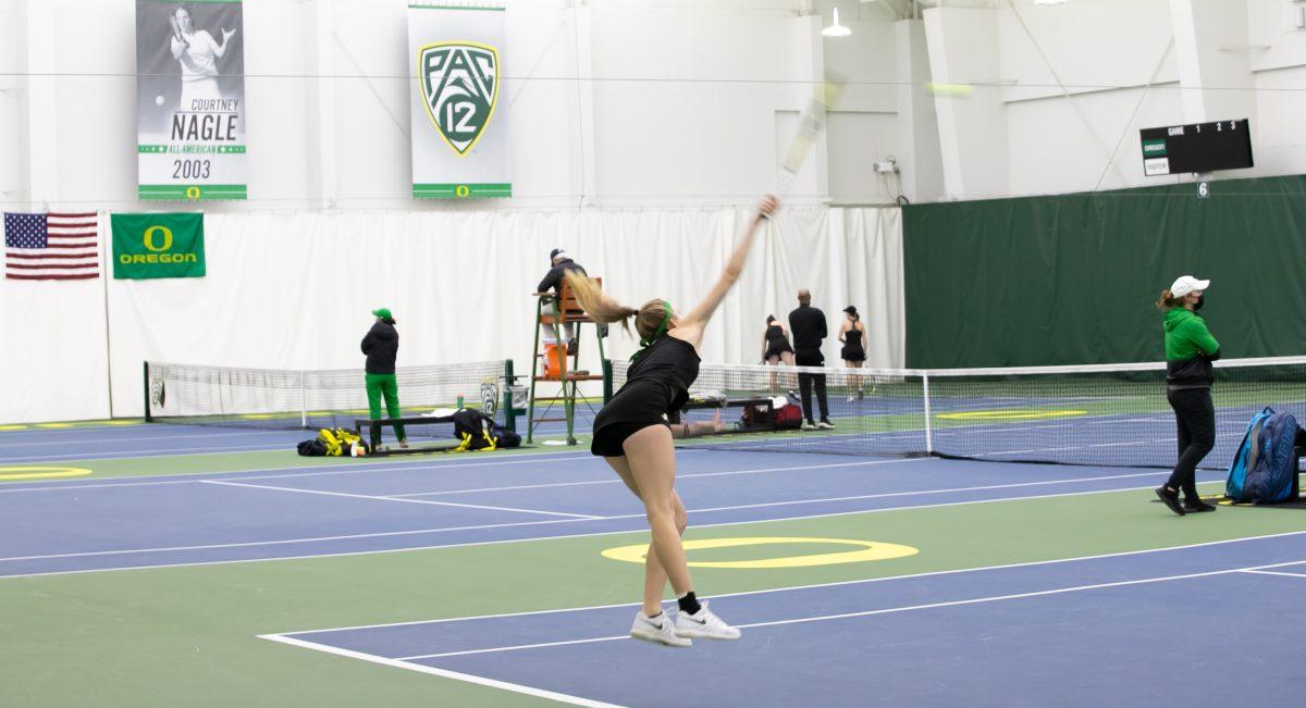 Myah Petchey jumps to deliver a strong serve to her opponent. The Oregon Ducks face off against the Seattle U Redhawks on February 19th, 2022. (Liam Sherry/Emerald)