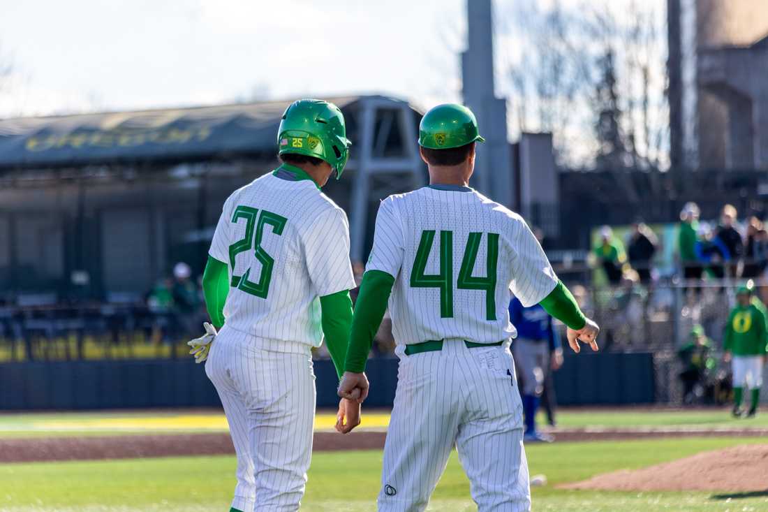 Oregon&#8217;s Jacob Walsh (25) confers with the third base coach. The Oregon Ducks Baseball team takes on UCSB on March 5th, 2022, at PK Park. (Molly McPherson/Emerald)