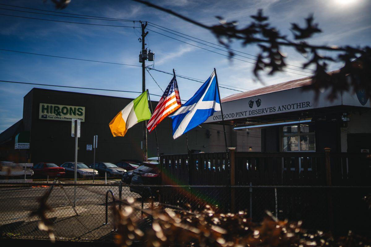 An Irish, American, and Scottish flag fly outside of the Pint Pot Public House. The Pint Pot Public House is an Irish pub located in downtown Eugene, serving food and drinks since 2014. (Will Geschke/Emerald)