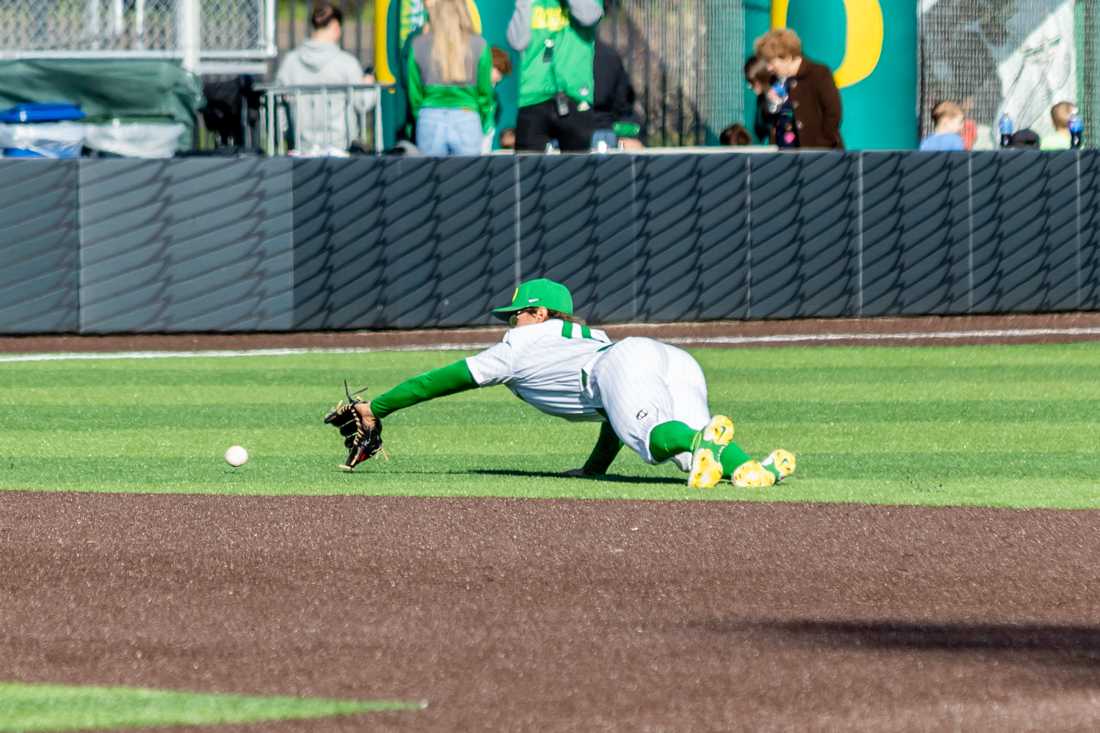 Josh Kasevich (04) dives to stop the ball from entering the outfield. The Oregon Ducks Baseball team takes on UCSB on March 5th, 2022, at PK Park. (Molly McPherson/Emerald)