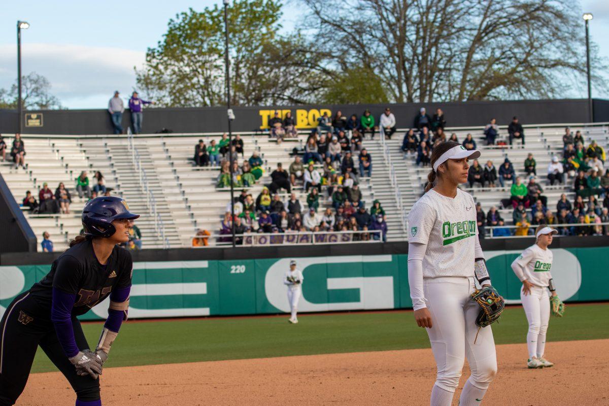 Tehya Bird (44), waits patiently alongside an opposing Husky for the pitcher to throw. The Oregon Ducks Softball Team hosts Washington on April 22nd, 2022, at Jane Sanders Stadium. (Jonathan Suni,Emerald)