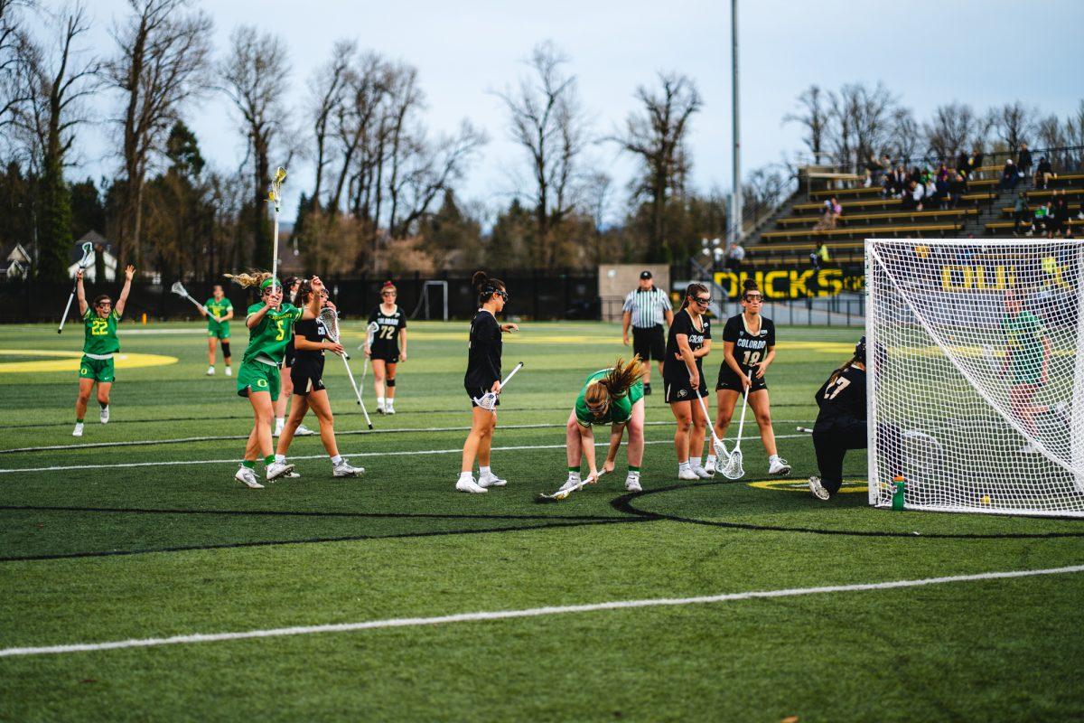 Lillian Stump slams her lacrosse stick into the ground to celebrate her goal, which was later disallowed. The University of Oregon Ducks lost to the University of Colorado Buffaloes 11-9 at PK Park on March 18, 2022. (Will Geschke/Emerald)