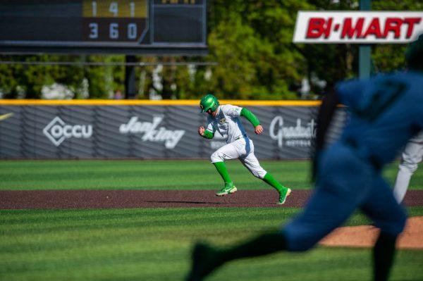 Sam Novitske (9) bolts to third base while Ducks’ hitter heads to first. Oregon Baseball takes on University of Arizona at PK Field in Eugene, Ore. on May 20, 2022. (Mary Grosswendt/Emerald)