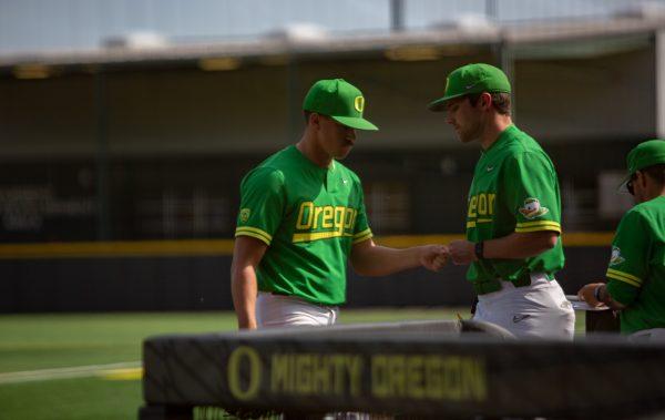 Logan Mercado is consoled by a teammate in the dugout after being pulled from the game. The Oregon Ducks Baseball team hosts Washington State at PK Park on April 24th, 2022. (Liam Sherry/Emerald)