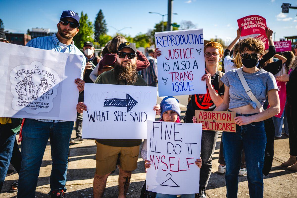 (From left to right) Nick Squire, Sammy Donohue, Eliana Barker, Emily Beatty, and a protester who requested to remain anonymous, pose for a photo at the protest. After a draft of a supreme court opinion that would overturn Roe V. Wade was leaked the day prior, hundreds of protesters gathered on May 3, 2022 to march through downtown Eugene in protest. (Will Geschke/Emerald)