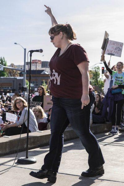 A speaker walks off to cheers from the crowd after delivering a speech. After a draft of a supreme court opinion would overturn Roe V. Wade was leaked the day prior, hundreds of protesters gathered on May 3, 2022 to march through downtown Eugene in protest. (Maddie Stellingwerf/Emerald)