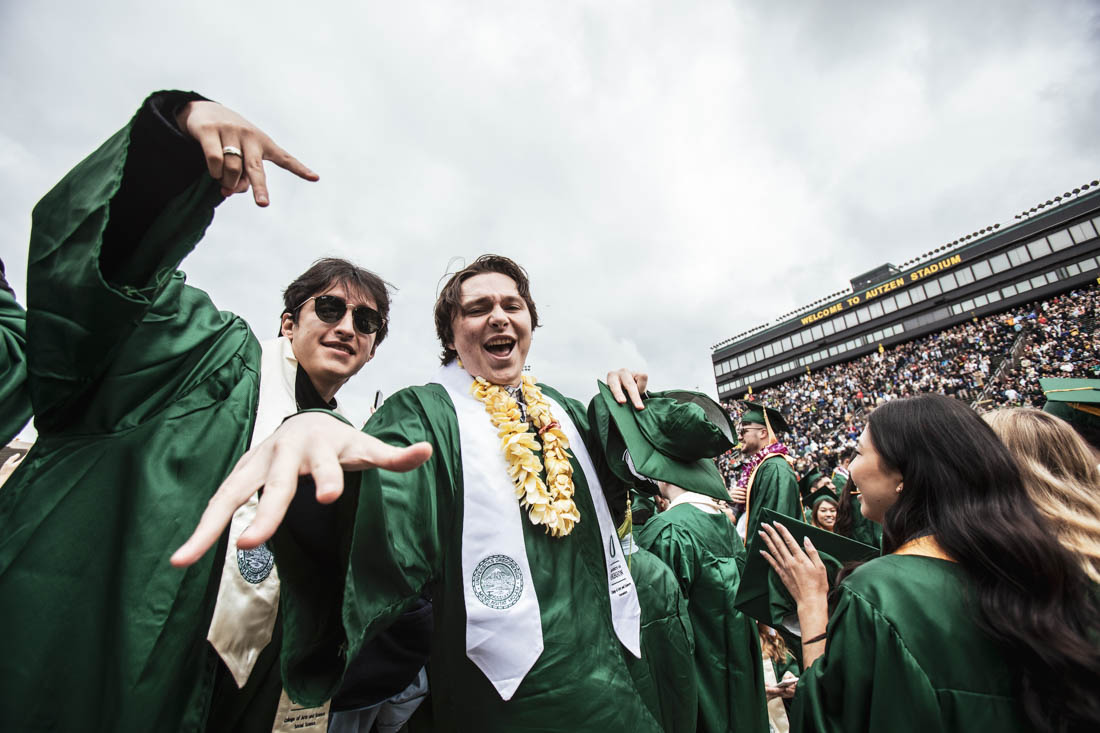 Graduates are all smiles after the commencement ceremony comes to a close and graduation festivities begin. University of Oregon holds its 2022 Commencement Ceremony at Autzen Stadium in Eugene, Ore., on June 13, 2022. (Maddie Stellingwerf/Emerald)